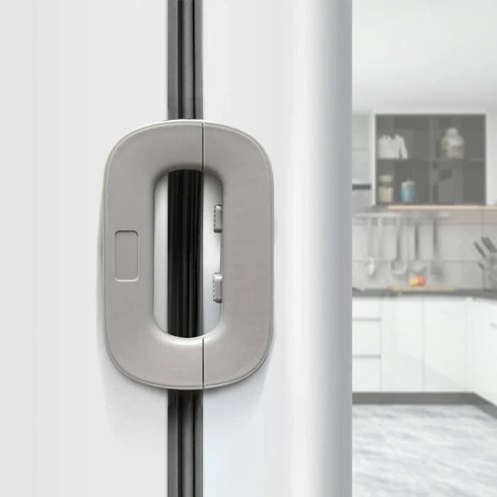 Close-up of a modern kitchen cabinet handle with a blurred background