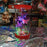 Decorative lamp with colorful LED lights, butterflies, and a character on a reflective surface.
