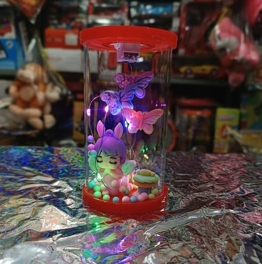 Decorative lamp with colorful LED lights, butterflies, and a character on a reflective surface.