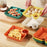 Colorful food platters with compartments on a wooden table