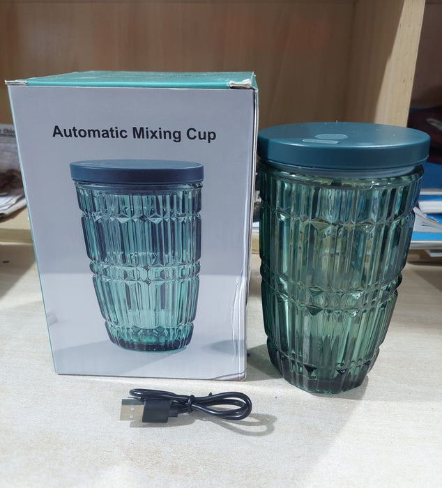 Blue textured mixing cup with USB cable next to its packaging on a light surface.Automatic self-stirring glass cup with food-grade material and mixing rod – Rs.999"

"Self-stirring mug for coffee, tea, and juice mixing – Rs.999 only"

"Reusable automatic mixing cup with elegant glass design – Rs.999 deal"