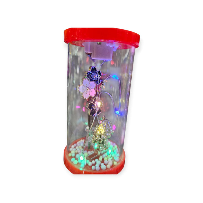 Decorative jar with colorful lights and beads on a white background